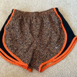 Nike Orange and Black Athletic Shorts with Bold Design